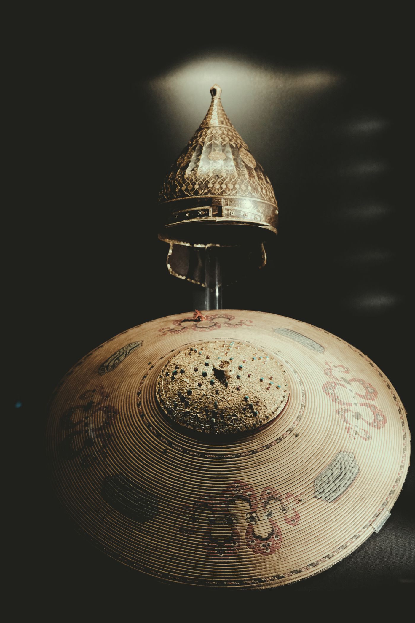 A decorated shield and helmet, a thematic photograph about knighthood.