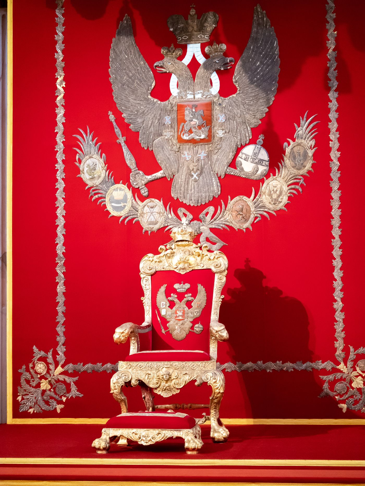 An ornate empty ceremonial throne, illustrating the staged appearance of sovereignty.