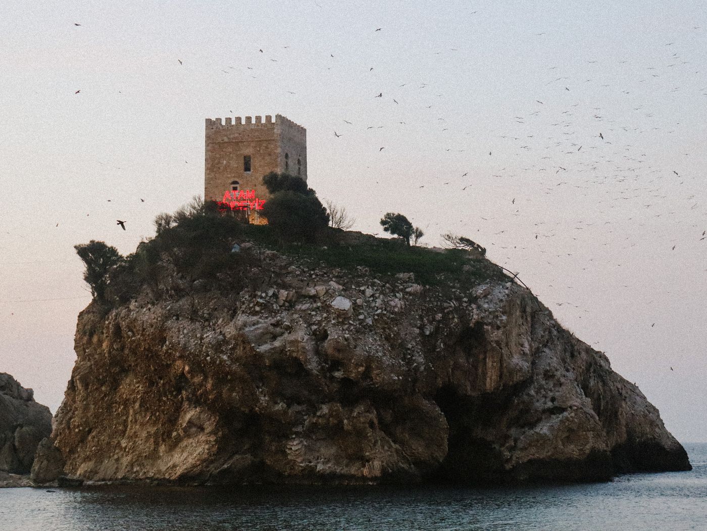 A stone tower on a rocky island, illustrating the defensive isolation of Dragonstone.