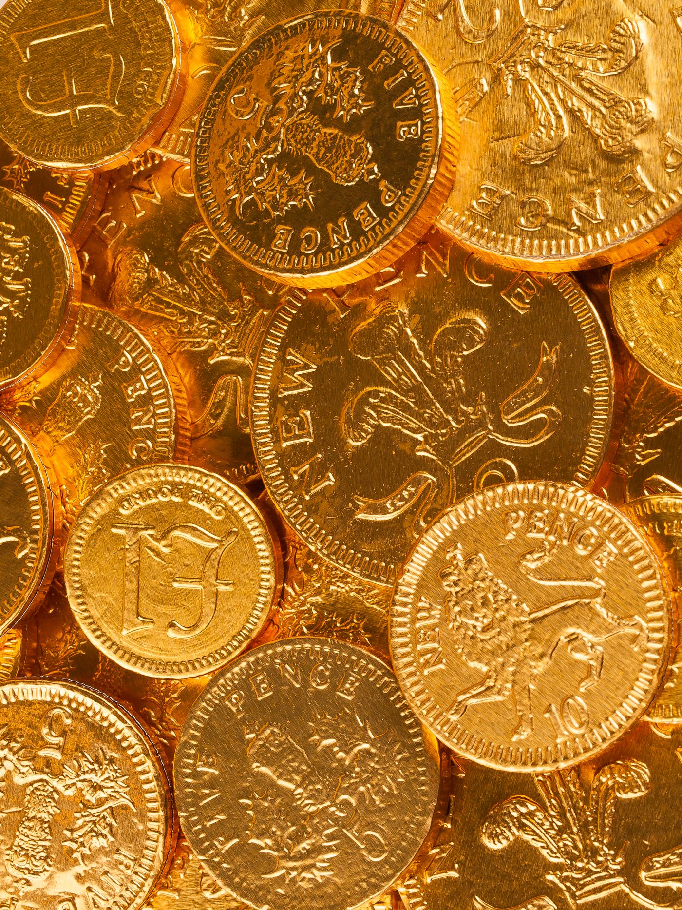 Gold-coloured coins with heraldic emblems, a thematic photograph about wealth and trust.