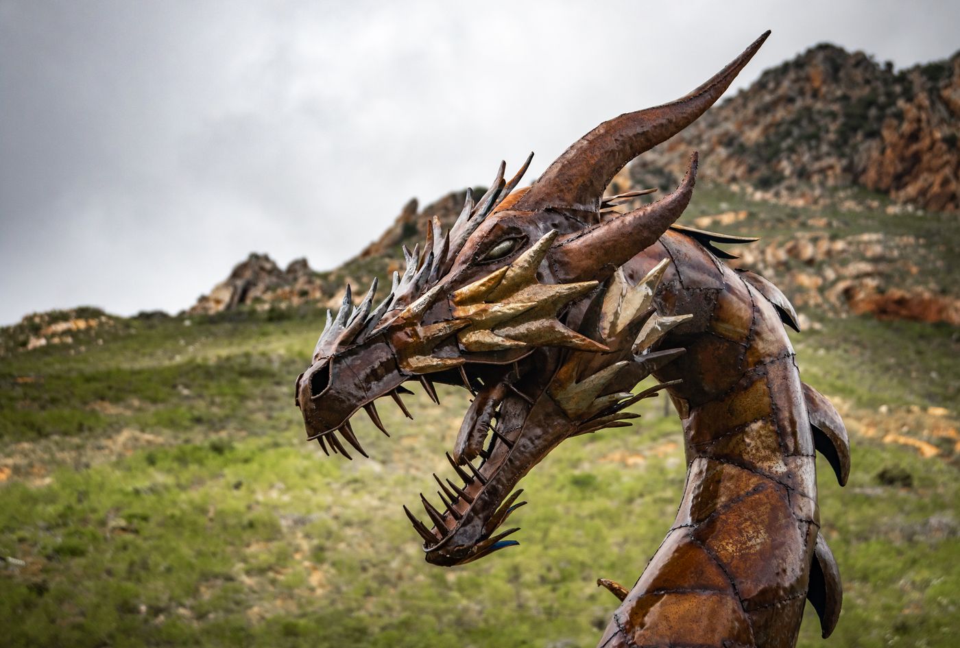 A metal dragon sculpture in a rugged landscape; a thematic photograph, not the Targaryen sigil.