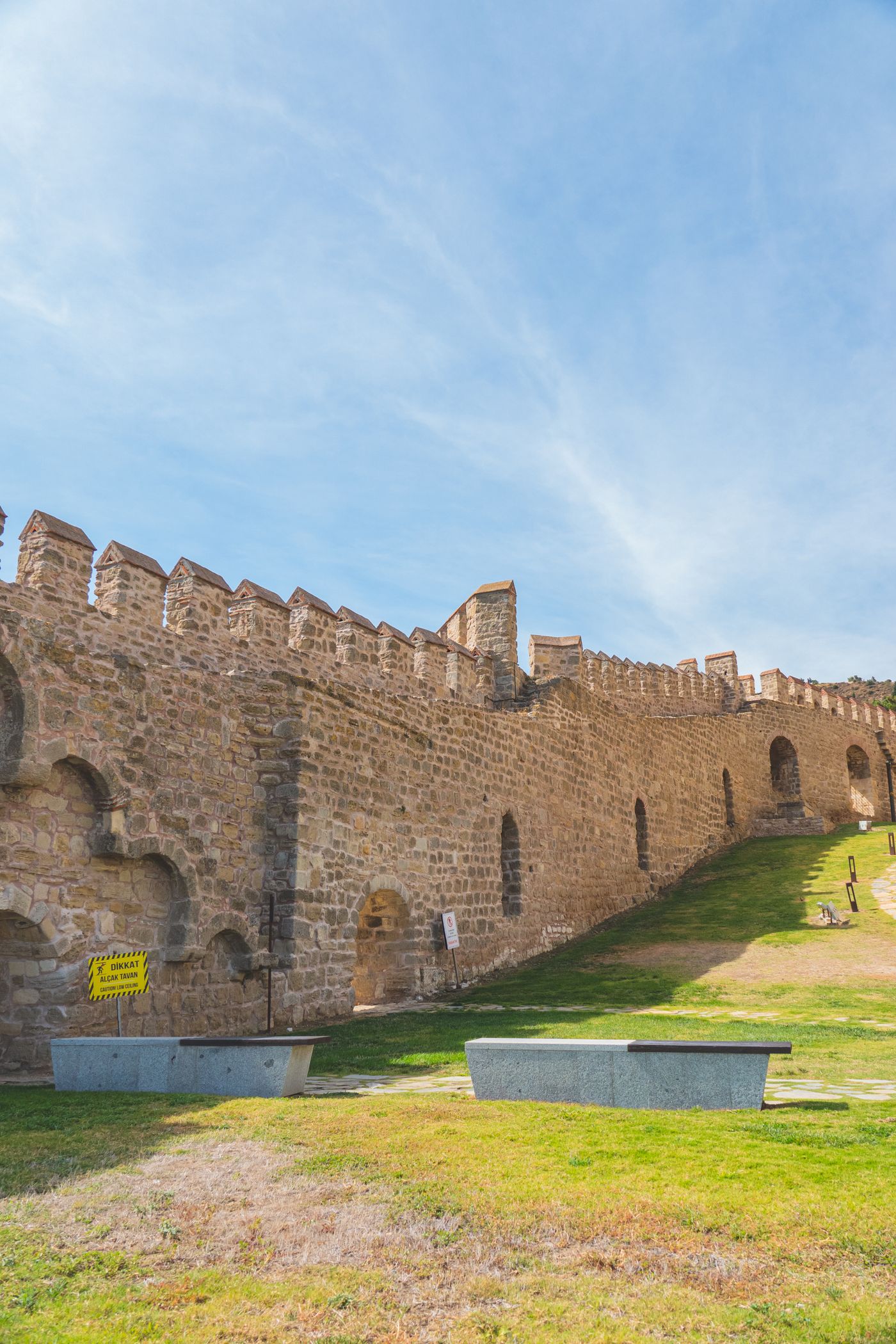 A fortified stone wall extending into the distance, illustrating a defended border.